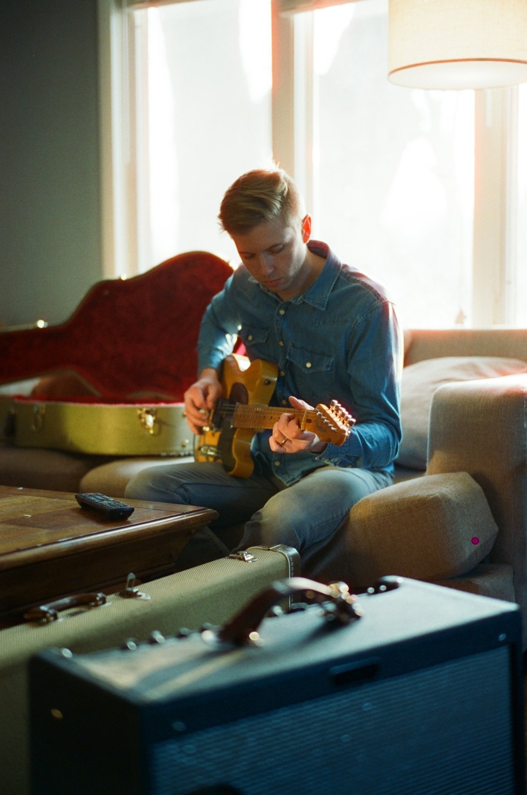 Jack Winders playing guitar at home